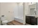 Bathroom featuring a tub and shower, a vanity with sink, and a toilet at 12940 Jasmine St # A, Thornton, CO 80602