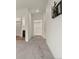 Hallway leads to bathroom and closet with TV mount on the wall at 12940 Jasmine St # A, Thornton, CO 80602