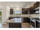 Beautiful modern kitchen with stainless steel appliances, granite countertops, and ample cabinet space at 12940 Jasmine St # A, Thornton, CO 80602