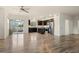 Modern kitchen featuring hardwood floors, stainless steel appliances, and a large island with countertop at 12940 Jasmine St # A, Thornton, CO 80602