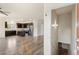 Open-concept kitchen, stainless steel appliances, and entryway leading to the upper level at 12940 Jasmine St # A, Thornton, CO 80602