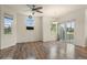 Bright living room featuring hardwood floors, large windows, and sliding glass doors to the outside at 12940 Jasmine St # A, Thornton, CO 80602