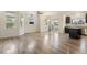 Bright open floor plan featuring hardwood floors with living room and island at 12940 Jasmine St # A, Thornton, CO 80602