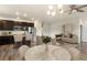 Open floor plan showcases the kitchen, living, and dining areas with great natural light and style at 12940 Jasmine St # A, Thornton, CO 80602
