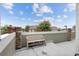 Exterior view of a concrete patio area with bench at 12940 Jasmine St # A, Thornton, CO 80602