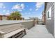 Concrete patio area with bench. Exterior view of home at 12940 Jasmine St # A, Thornton, CO 80602