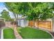 Backyard with artificial turf, shed, and privacy fence at 11978 W Aqueduct Dr, Littleton, CO 80127