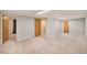 Finished basement with multiple doors and neutral carpeting at 11978 W Aqueduct Dr, Littleton, CO 80127