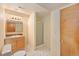 Bathroom featuring vanity, mirror, tile floors, and a shower at 11978 W Aqueduct Dr, Littleton, CO 80127