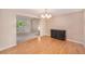 Open dining area with hardwood floors that leads to a carpeted living room at 11978 W Aqueduct Dr, Littleton, CO 80127