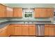 Kitchen featuring light wood cabinets, stainless steel appliances, and a window for natural light at 11978 W Aqueduct Dr, Littleton, CO 80127