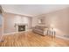 Comfortable living room featuring wood floors, fireplace, and natural lighting at 11978 W Aqueduct Dr, Littleton, CO 80127
