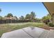 Large backyard with lawn and wood fence on a lot with mature trees and a patio just outside the back door at 9134 Bellaire St, Thornton, CO 80229