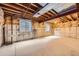 Spacious unfinished basement with insulated walls, concrete floor and a couple of windows at 9134 Bellaire St, Thornton, CO 80229