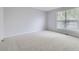 Bright, carpeted bedroom with a large window offering plenty of natural light at 9134 Bellaire St, Thornton, CO 80229