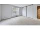 Bedroom with large closet and window; neutral color scheme at 9134 Bellaire St, Thornton, CO 80229