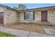 Close up of exterior with wood mulch landscaping, a window and a brown door at 9134 Bellaire St, Thornton, CO 80229