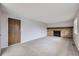 Spacious living room with a classic brick fireplace and neutral carpet at 9134 Bellaire St, Thornton, CO 80229