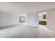 Open-concept living room with plush carpeting and plenty of natural light at 9134 Bellaire St, Thornton, CO 80229