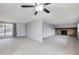 Large living room featuring brick fireplace and plush carpeting throughout at 9134 Bellaire St, Thornton, CO 80229