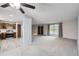 Bright and open living room seamlessly connects to the kitchen with stylish flooring and large windows at 9134 Bellaire St, Thornton, CO 80229