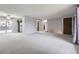 Spacious living room featuring gray walls, carpeting and access to other rooms at 9134 Bellaire St, Thornton, CO 80229