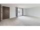 Neutral living room with carpeting, large window, and view of the front yard at 9134 Bellaire St, Thornton, CO 80229