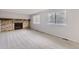 Bright living room featuring a brick fireplace and dual windows for natural light at 9134 Bellaire St, Thornton, CO 80229
