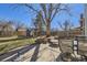 Spacious backyard with mature trees, a shed and a seating area with patio furniture at 8210 Hoyt Ct, Arvada, CO 80005