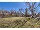 Large, sunny backyard with mature trees, shed and plenty of entertaining space at 8210 Hoyt Ct, Arvada, CO 80005