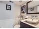 Stylish powder room featuring a modern sink, mirror, and decorative wall accents at 8210 Hoyt Ct, Arvada, CO 80005