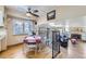 Charming dining area features hardwood floors, a ceiling fan, and a view into the cozy living room at 8210 Hoyt Ct, Arvada, CO 80005