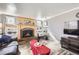 Bright living room boasts a brick fireplace with mantel and built-in shelves providing ample storage and charm at 8210 Hoyt Ct, Arvada, CO 80005