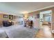 Cozy living room featuring plush carpeting, a comfortable armchair, and adjacent dining area at 8210 Hoyt Ct, Arvada, CO 80005