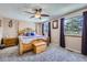 Comfortable main bedroom with plush carpet, natural light, and ceiling fan at 8210 Hoyt Ct, Arvada, CO 80005