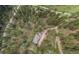 A high angle, bird's eye shot of the property, surrounded by verdant trees and natural landscape at 2545 N State Highway 67, Sedalia, CO 80135