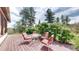 Charming deck features outdoor furniture, green grass and lush trees, ideal for relaxation at 2545 N State Highway 67, Sedalia, CO 80135