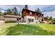 Expansive backyard with lush green lawn and a two-story house featuring a wood and stucco exterior at 2545 N State Highway 67, Sedalia, CO 80135