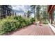 Charming deck features outdoor furniture, green grass and lush trees, ideal for relaxation at 2545 N State Highway 67, Sedalia, CO 80135