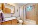Cozy bathroom features a shower-tub combo and a single sink vanity with wooden cabinets at 2545 N State Highway 67, Sedalia, CO 80135