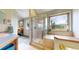 Bathroom featuring a glass enclosed shower, and a soaking tub with a large window with outdoor views at 2545 N State Highway 67, Sedalia, CO 80135