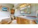A bathroom features ample lighting, cabinet space, a bathtub, and a toilet at 2545 N State Highway 67, Sedalia, CO 80135