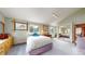 Cozy bedroom with large windows, mirrors and natural light and access to more rooms through the bedroom at 2545 N State Highway 67, Sedalia, CO 80135
