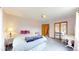 Bedroom featuring natural light, a bed, vanity, and entryways to other areas in the home at 2545 N State Highway 67, Sedalia, CO 80135