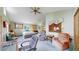 Bright bedroom with a ceiling fan, multiple windows and natural light, seating, and ample workspace at 2545 N State Highway 67, Sedalia, CO 80135