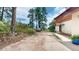 Long dirt driveway leading to a house nestled in the trees, with a partial view of the home's entrance at 2545 N State Highway 67, Sedalia, CO 80135