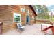 Charming cabin features a spacious deck perfect for outdoor living and enjoying the surrounding natural beauty at 2545 N State Highway 67, Sedalia, CO 80135
