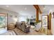Bright living room featuring hardwood floors, neutral paint, and large windows at 2545 N State Highway 67, Sedalia, CO 80135