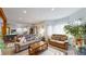 Cozy living room featuring hardwood floors, neutral paint, and large windows for natural light at 2545 N State Highway 67, Sedalia, CO 80135