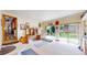 Bright recreation room featuring exercise equipment, built-in shelves, and a sliding glass door at 2545 N State Highway 67, Sedalia, CO 80135